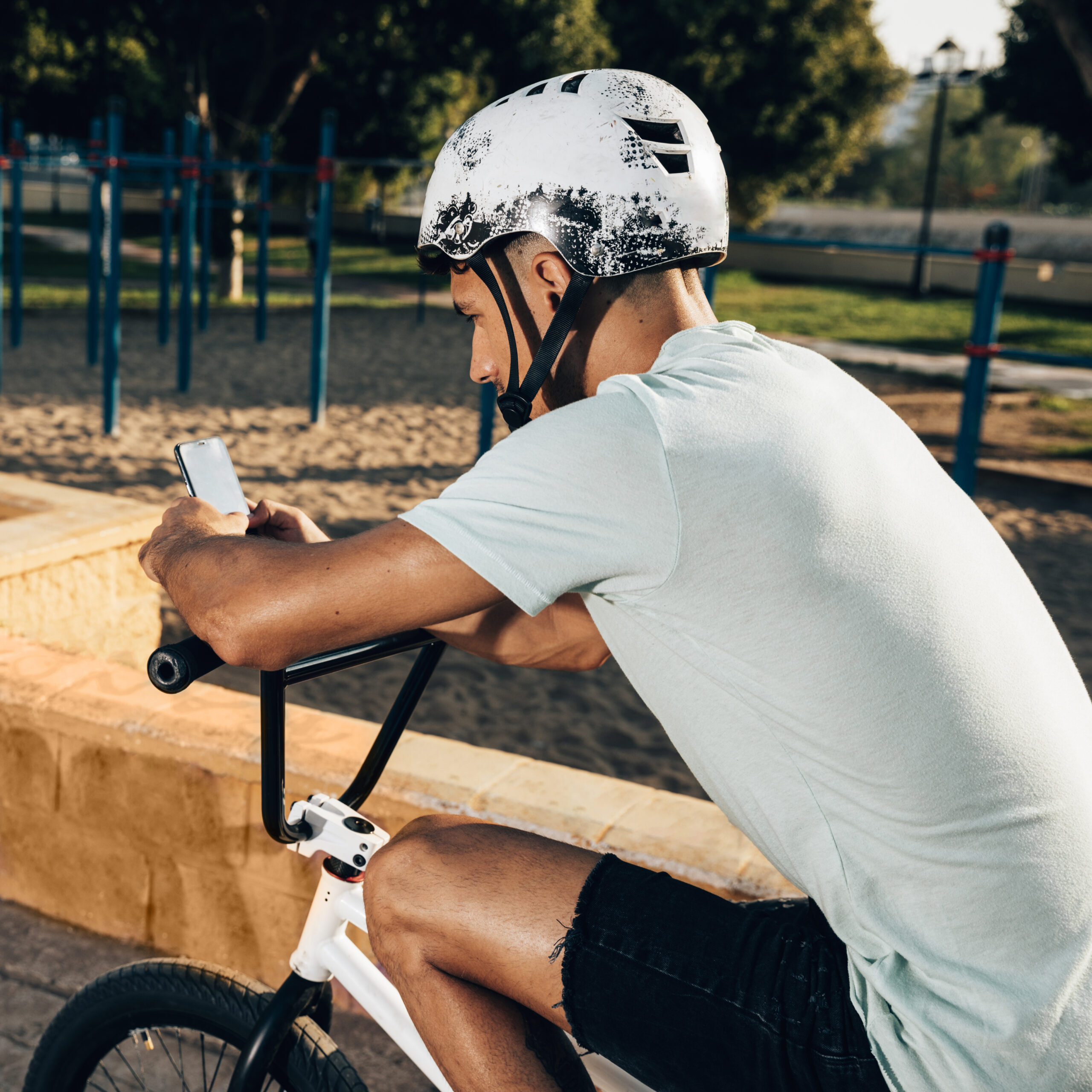 bmx-rider-cheking-out-his-phone-medium-shot